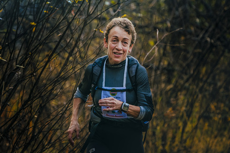 Beloretsk, Russia -  September 26, 2015: woman of senior years running through woods during marathon mountain "Big Iremel"のeditorial素材