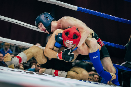 Volgograd, Russia - October 24, 2015: two mixed martial arts fighter lead fight on floor ring during...