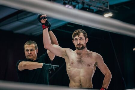 Volgograd, Russia - October 24, 2015: fighter mixed martial arts blow to head opponent lying on floor during Championship of Russia on mixed martial artsのeditorial素材