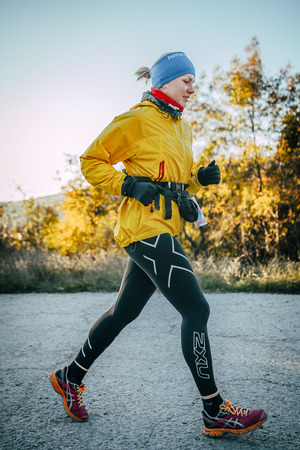 Yalta, Russia - October 31, 2015: young girl running down road during First Yalta mountain marathonのeditorial素材