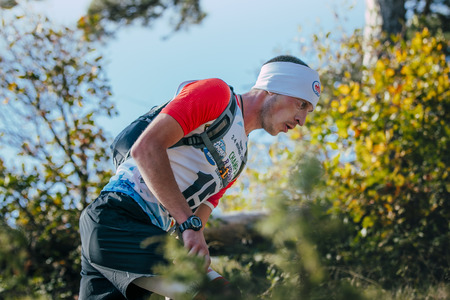Yalta, Russia - November 4, 2015: closeup face of young man runner around autumn landscape during mountain marathon Taurisのeditorial素材