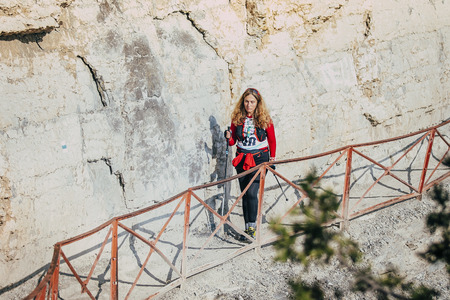 Yalta, Russia - November 4, 2015: young girl athlete goes on trail along cliff rocks during mountain marathon Taurisのeditorial素材
