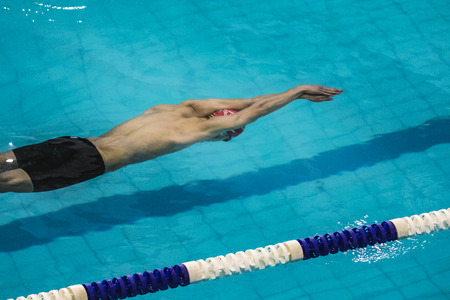 Chelyabinsk, Russia - October 21, 2015: start athlete swimmer in distance freestyle. swimming under water during Championship of Chelyabinsk swimmingのeditorial素材