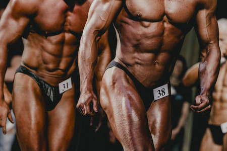 Chelyabinsk, Russia - October 3, 2015: athletes bodybuilders are sideways strain of thigh muscles during Championship of Chelyabinsk region on bodybuilding, bodyfitness and fitnessのeditorial素材