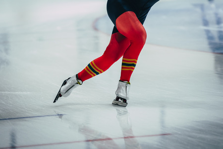 closeup feet women athletes skater during race at sprint distance. speed skating  indoorsの写真素材