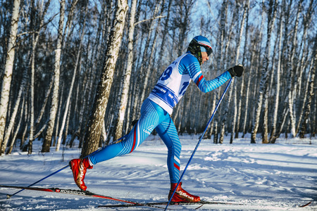 Chelyabinsk, Russia -  December 19, 2015: side view young skier athlete winter birch forest sprint race in classic style during Championship of Chelyabinsk in cross-country skiingのeditorial素材