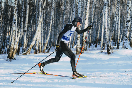 Chelyabinsk, Russia -  December 19, 2015: side view young skier athlete sprint race in classic stylel during Championship of Chelyabinsk in cross-country skiingのeditorial素材
