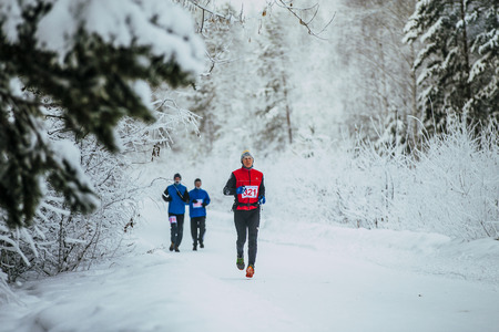 Chelyabinsk, Russia -  January 5, 2016: group athletes runners running in winter snow-covered forest during Chelyabinsk winter marathonのeditorial素材