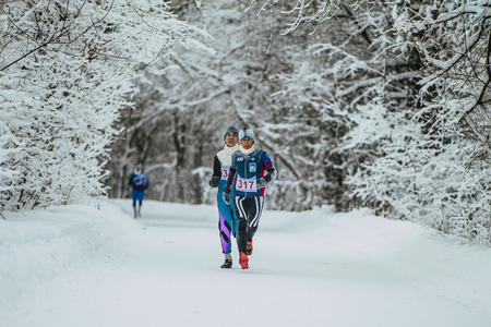 Chelyabinsk, Russia -  January 5, 2016: athletes leaders of race run on track in winter forest during Chelyabinsk winter marathonのeditorial素材