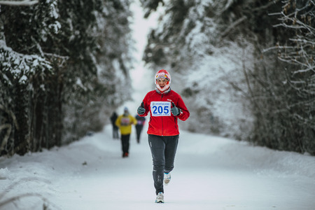 Chelyabinsk, Russia -  January 5, 2016: middle-aged man runner while running in cold weather during Chelyabinsk winter marathonのeditorial素材