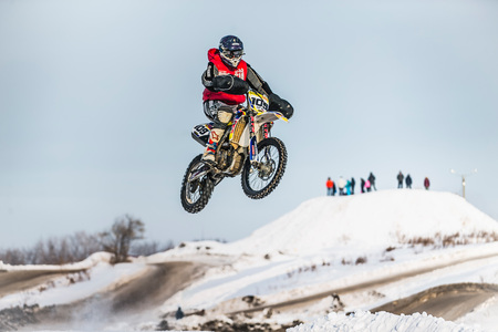 Kopeysk, Russia -  January 23, 2016: high jump motorcycle racer on snow covered hill during Cup Winter motocrossのeditorial素材