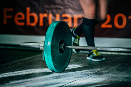 barbel deadlift on a wooden floor. athlete of powerlifter is preparing to attemptの写真素材