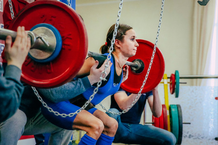 Chelyabinsk, Russia - February 12, 2016: female athlete of powerlifter squats barbell during West Asian championship 2016 WPC-AWPC powerliftingのeditorial素材