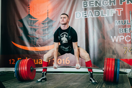 Chelyabinsk, Russia - February 12, 2016: man of powerlifter attempt deadlift heavy barbell during West Asian championship 2016 WPC-AWPC powerliftingのeditorial素材