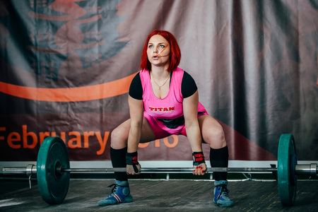 Chelyabinsk, Russia - February 12, 2016: young female athlete performs deadlift barbell during West Asian championship 2016 WPC-AWPC powerliftingのeditorial素材