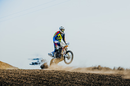 Miasskoe, Russia - May 02, 2016: racer on a motorcycle rides on rear wheel on a dusty track during Cup of Urals motocrossのeditorial素材