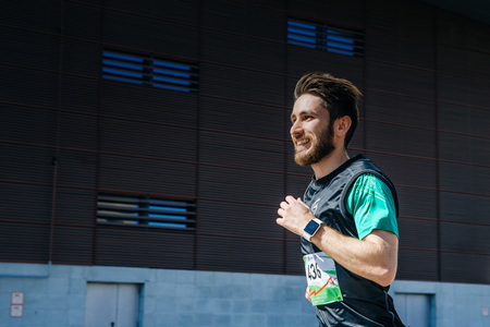 Ekaterinburg, Russia - May 3, 2016: young man runs through city, a smile on his face during City marathonのeditorial素材