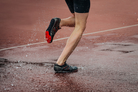 athlete foot men running steeplechase. a spray of waterの写真素材