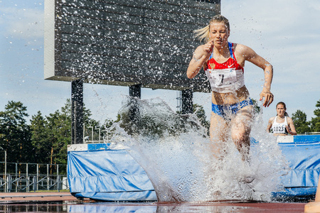 Chelyabinsk, Russia - May 24, 2016: female athletes leader of  race at steeplechase during UrFO Championship in athleticsのeditorial素材