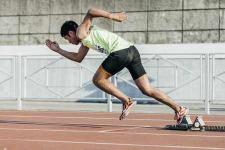 Chelyabinsk, Russia - May 24, 2016: male athlete starts from starting blocks on a distance of 400 meters during UrFO Championship in athleticsのeditorial素材