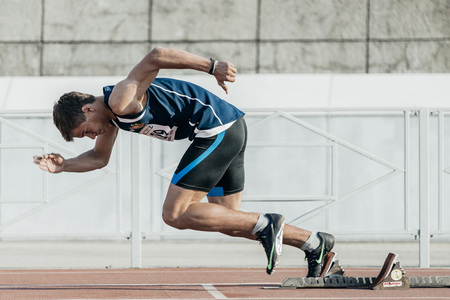 Chelyabinsk, Russia - May 24, 2016: male runner starts from starting blocks on a distance of 400 meters during UrFO Championship in athleticsのeditorial素材