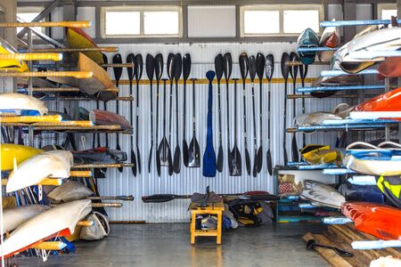 warehouse for storage of boats, canoes and kayaks, paddleの写真素材