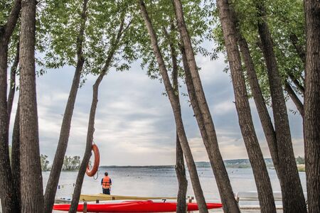 canoes and kayaks on shore lake. far distance for competitions in rowingの写真素材