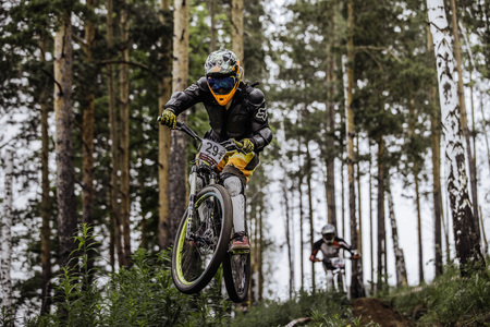 Miass, Russia - May 29, 2016: jump and fly racer on bike in woods during Cup "Ryder" downhillのeditorial素材