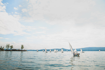Miass, Russia - June 7, 2016: group of young athletes on boats of Optimist class sailing on lake during Cup regatta Fyodor Konyukhovのeditorial素材