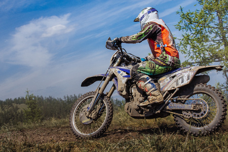 Kyshtym, Russia - June 19, 2016: biker on mountain on blue sky background during Ural Cup in Enduroのeditorial素材