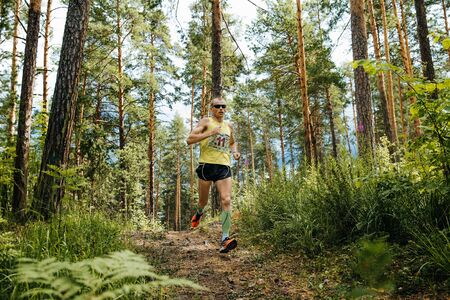 Miass, Russia - June 26, 2016: athlete leader of race runs along trail in woods during Marathon "Clean water"のeditorial素材