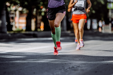 feet young woman athletes compression socks running marathonの写真素材