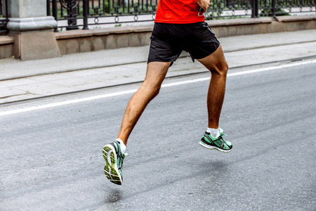 side view of legs of male athlete running sports raceの写真素材