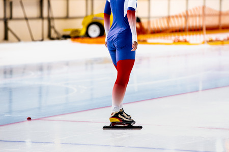female athletes skaters during competitions in speed skating at starting lineの写真素材