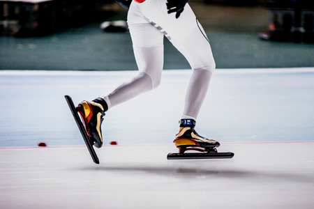 closeup of legs of women speed skaters at competitions in speed skatingの写真素材