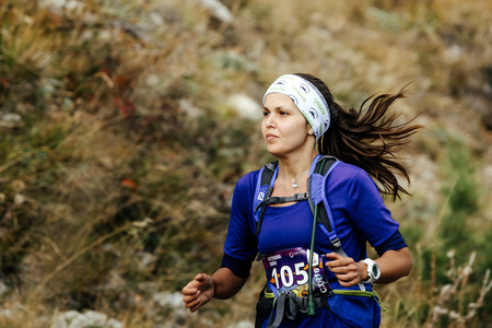 closeup of young female runner skyrunner running mountain landscape during Crimea mountain marathonのeditorial素材
