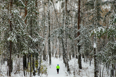 General plan fat woman running in winter snow pine forestの写真素材