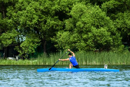 male athlete rowers canoeists paddling on lake rowing competitions