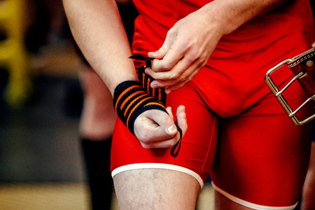 male hands athlete powerlifter with wristbands and belt powerliftingの写真素材