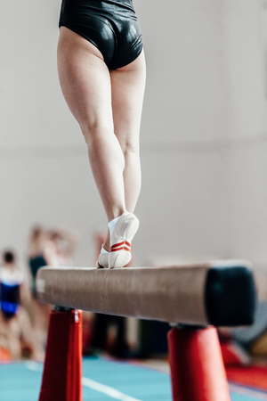 back part of body female gymnast exercises on balance beamの写真素材