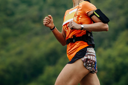 running girl athlete on hand watch and smartphone is caseの写真素材