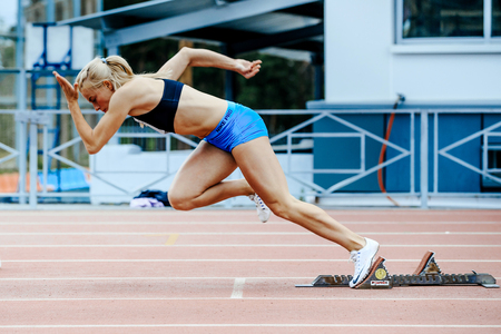 Chelyabinsk, Russia - June 4, 2017: explosive start female athlete sprinter run 200 meters during UrFO Championship in athleticsのeditorial素材