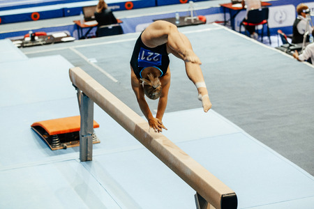 woman gymnast acrobatic skill in balance beam gymnasticsの写真素材