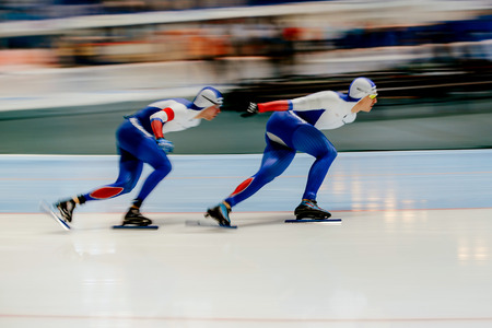 Chelyabinsk, Russia - November 14, 2017: blurred motion two men speed skaters to warm up during Cup in speed skatingのeditorial素材