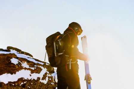 Alpine skiing man athlete skier in bokeh sunの写真素材