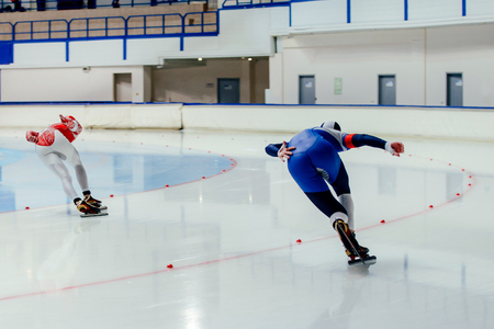back two athletes skater on competition in speed skating