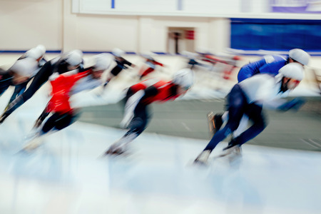 mass start men athletes ice skaters blurred motionの写真素材