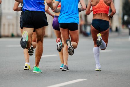 leaders group of runners men and women running city marathonの写真素材