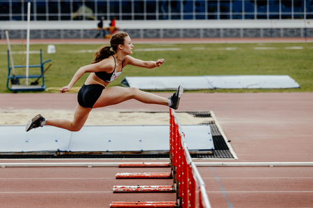 Chelyabinsk, Russia - June 2, 2018: women athlete running in 100 meter hurdles during UrFO Championship in athleticsのeditorial素材