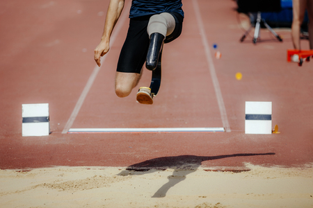 athlete jumper with limb loss leg long jump at track and field competitionの写真素材